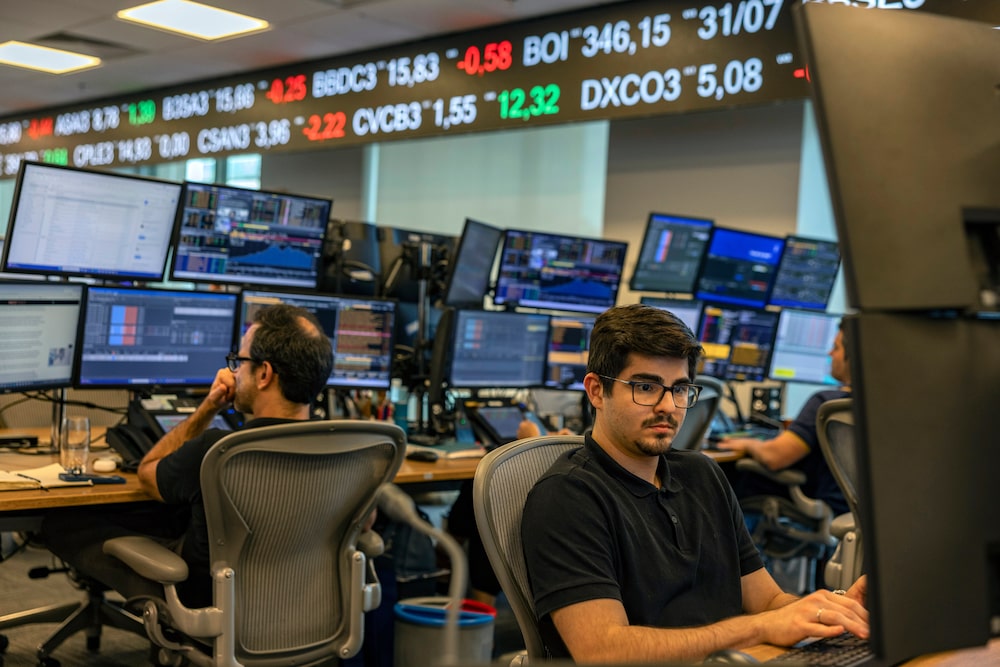 Employees work on the trading floor at the Genial Investments headquarters in Sao Paulo, Brazil, on Wednesday, Aug. 5, 2026. Brazilian economists cut their 2026 year-end benchmark interest rate forecast as Latin America's largest economy shows mounting signs of cooling down. Photographer: Victor Moriyama/Bloomberg Employees work on the trading floor at the Genial Investments headquarters in Sao Paulo, Brazil, on Wednesday, Aug. 5, 2026. Brazilian economists cut their 2026 year-end benchmark interest rate forecast as Latin America's largest economy shows mounting signs of cooling down. Photographer: Victor Moriyama/Bloomberg