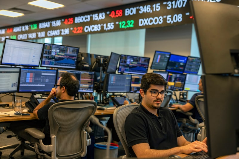Employees work on the trading floor at the Genial Investments headquarters in Sao Paulo, Brazil, on Wednesday, Aug. 5, 2026. Brazilian economists cut their 2026 year-end benchmark interest rate forecast as Latin America's largest economy shows mounting signs of cooling down. Photographer: Victor Moriyama/Bloomberg Employees work on the trading floor at the Genial Investments headquarters in Sao Paulo, Brazil, on Wednesday, Aug. 5, 2026. Brazilian economists cut their 2026 year-end benchmark interest rate forecast as Latin America's largest economy shows mounting signs of cooling down. Photographer: Victor Moriyama/Bloomberg