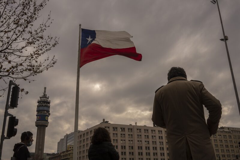 A Chilean flag flying above the Palacio de La Moneda in Santiago, Chile. A Chilean flag flying above the Palacio de La Moneda in Santiago, Chile.