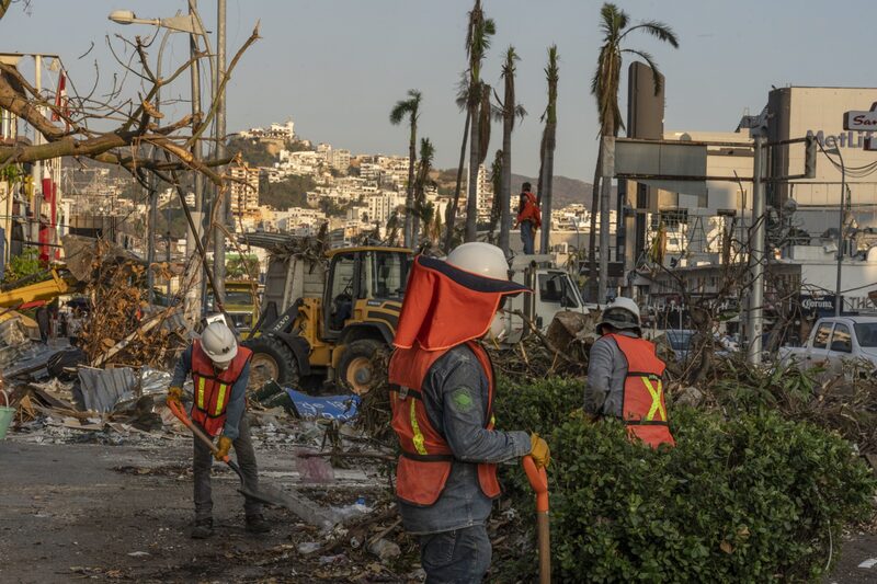 Construction workers clean up debris in the aftermath of Hurricane Otis in Acapulco, Guerrero state, Mexico, on Tuesday, Nov. 14, 2023. Mexico's lower house of Congress approved the spending portion of the 2024 budget and sent it to the president for signing, without including extra funding for the recovery of hurricane-hit Acapulco. Photographer: Alejandro Cegarra/Bloomberg Construction workers clean up debris in the aftermath of Hurricane Otis in Acapulco, Guerrero state, Mexico, on Tuesday, Nov. 14, 2023. Mexico's lower house of Congress approved the spending portion of the 2024 budget and sent it to the president for signing, without including extra funding for the recovery of hurricane-hit Acapulco. Photographer: Alejandro Cegarra/Bloomberg