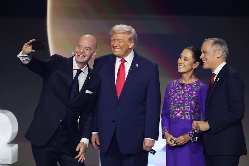 U.S. President Donald Trump, Claudia Sheinbaum, President of Mexico, and Mark Carney, Prime Minister of Canada, pose for a selfie with Gianni Infantino, President of FIFA, during the FIFA World Cup 2026 Official Draw at John F. Kennedy Center for the Performing Arts on December 05, 2025 in Washington, DC. (Photo by Hector Vivas - FIFA/FIFA via Getty Images) U.S. President Donald Trump, Claudia Sheinbaum, President of Mexico, and Mark Carney, Prime Minister of Canada, pose for a selfie with Gianni Infantino, President of FIFA, during the FIFA World Cup 2026 Official Draw at John F. Kennedy Center for the Performing Arts on December 05, 2025 in Washington, DC. (Photo by Hector Vivas - FIFA/FIFA via Getty Images)
