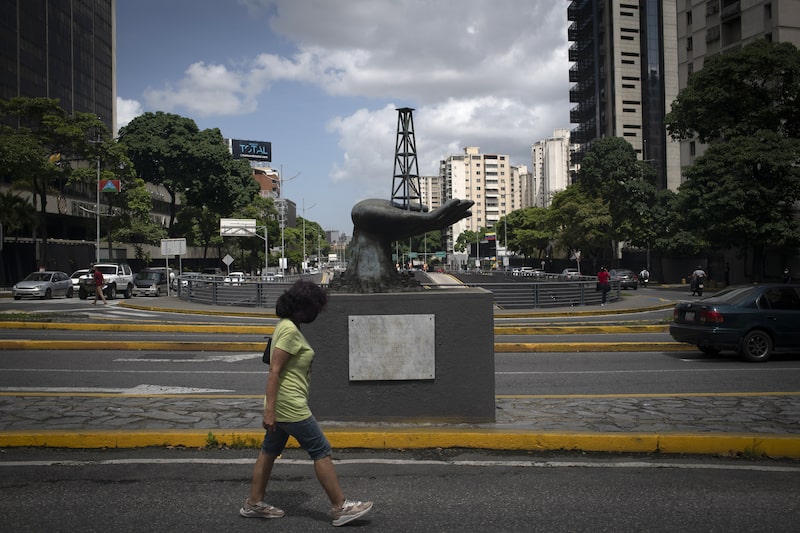 A pedestrians walks past a sculpture, depicting an oil derrick in a hand, outside the Petroleos de Venezuela SA (PDVSA) headquarters in Caracas, Venezuela, on Wednesday, Aug. 31, 2022. Venezuelan Oil Minister El Aissami made a request through the prosecutor's office for the extradition of ex-minister, Rafael Ramirez, for allegedly defrauding state oil company PDVSA. Photographer: Carolina Cabral/Bloomberg A pedestrians walks past a sculpture, depicting an oil derrick in a hand, outside the Petroleos de Venezuela SA (PDVSA) headquarters in Caracas, Venezuela, on Wednesday, Aug. 31, 2022. Venezuelan Oil Minister El Aissami made a request through the prosecutor's office for the extradition of ex-minister, Rafael Ramirez, for allegedly defrauding state oil company PDVSA. Photographer: Carolina Cabral/Bloomberg