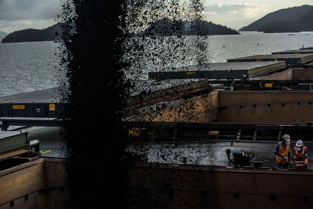 Iron ore is released onto a freighter at a port in Sepetiba Bay in Rio de Janeiro. Photographer: Dado Galdieri/Bloomberg Iron ore is released onto a freighter at a port in Sepetiba Bay in Rio de Janeiro. Photographer: Dado Galdieri/Bloomberg