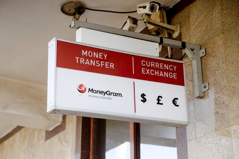 A sign for MoneyGram International Inc. money transfer and currency exchange services. A sign for MoneyGram International Inc. money transfer and currency exchange services.