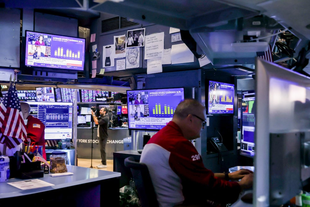 A television station broadcasts average hourly earnings as traders work on the floor of the New York Stock Exchange (NYSE) in New York, US, on Friday, June 5, 2026. Wall Streets historic weekly run is poised to come to a halt, with stocks and bonds falling after a solid jobs report added to speculation the Federal Reserves next interest-rate move will be a hike. Photographer: Michael Nagle/Bloomberg A television station broadcasts average hourly earnings as traders work on the floor of the New York Stock Exchange (NYSE) in New York, US, on Friday, June 5, 2026. Wall Streets historic weekly run is poised to come to a halt, with stocks and bonds falling after a solid jobs report added to speculation the Federal Reserves next interest-rate move will be a hike. Photographer: Michael Nagle/Bloomberg
