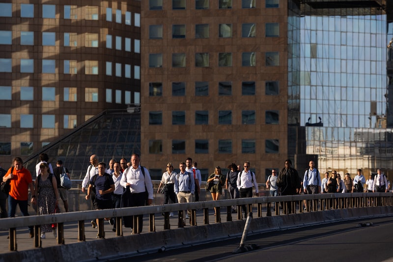 Commuters cross London Bridge in London. Photographer: Chris Ratcliffe/Bloomberg Commuters cross London Bridge in London. Photographer: Chris Ratcliffe/Bloomberg