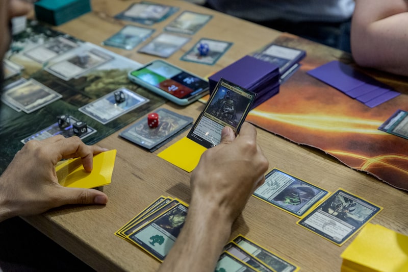 Participants play a Magic: The Gathering card game during a weekly tournament at the Uncommons hobby shop in New York, U.S., on Thursday, June 27, 2019. In the battle for gaming dominance, Hasbro Inc. has what it hopes is an ace up its sleevein a deck of playing cards that hit the market 26 years ago. Photographer: Mark Abramson/Bloomberg Participants play a Magic: The Gathering card game during a weekly tournament at the Uncommons hobby shop in New York, U.S., on Thursday, June 27, 2019. In the battle for gaming dominance, Hasbro Inc. has what it hopes is an ace up its sleevein a deck of playing cards that hit the market 26 years ago. Photographer: Mark Abramson/Bloomberg