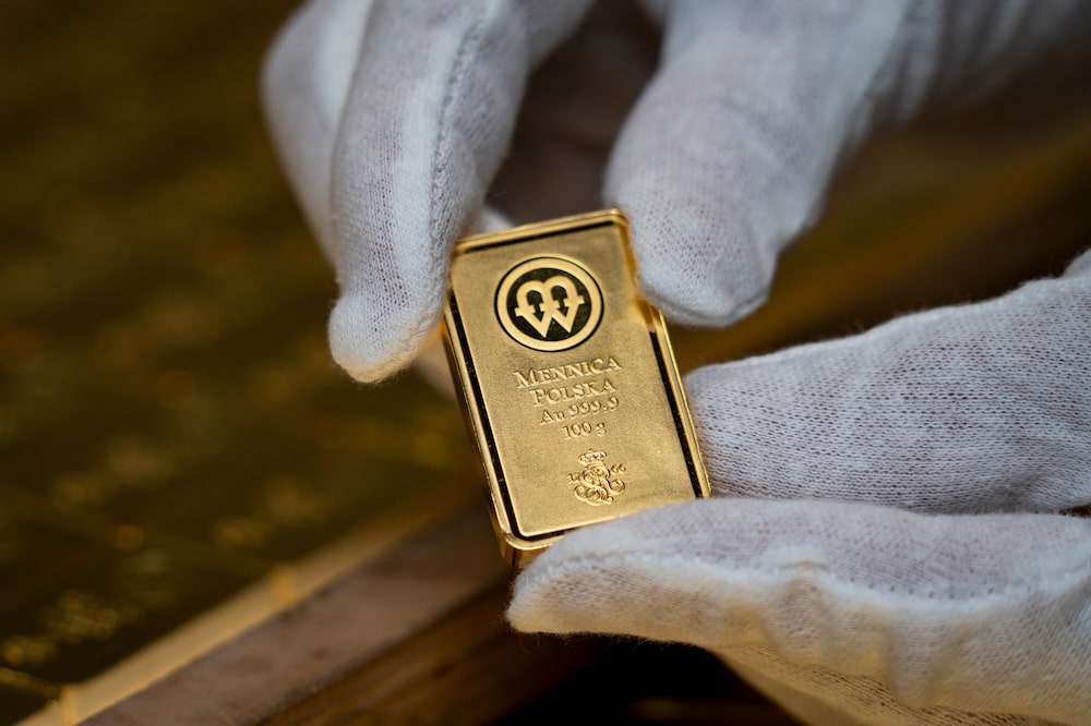 A 100 gram gold bar minted at the Polish mint, also known as Mennica Polska SA, in Warsaw, Poland, on Thursday, Feb. 12, 2026. Polands central bank, the worlds biggest reported buyer of gold, is boosting purchases by another 150 tons as it braces for more of the geopolitical instability that has driven prices to record highs. Photographer: Damian Lemanski/Bloomberg A 100 gram gold bar minted at the Polish mint, also known as Mennica Polska SA, in Warsaw, Poland, on Thursday, Feb. 12, 2026. Polands central bank, the worlds biggest reported buyer of gold, is boosting purchases by another 150 tons as it braces for more of the geopolitical instability that has driven prices to record highs. Photographer: Damian Lemanski/Bloomberg