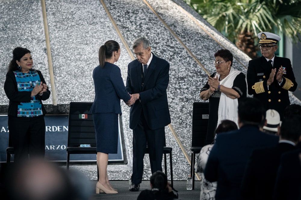 Cuauhtemoc Cardenas Solorzano, former head of government of Mexico City, center right, and Claudia Sheinbaum, Mexico's president, center left, shake hands during an event commemorating the 87th anniversary of Mexico's oil expropriation, at the Pemex headquarters in Mexico City, Mexico, on Tuesday, March 18, 2025. Mexico is the largest supplier of foreign crude oil to refineries on the US Gulf Coast. Photographer: Mayolo Lopez Guiterrez/Bloomberg Cuauhtemoc Cardenas Solorzano, former head of government of Mexico City, center right, and Claudia Sheinbaum, Mexico's president, center left, shake hands during an event commemorating the 87th anniversary of Mexico's oil expropriation, at the Pemex headquarters in Mexico City, Mexico, on Tuesday, March 18, 2025. Mexico is the largest supplier of foreign crude oil to refineries on the US Gulf Coast. Photographer: Mayolo Lopez Guiterrez/Bloomberg