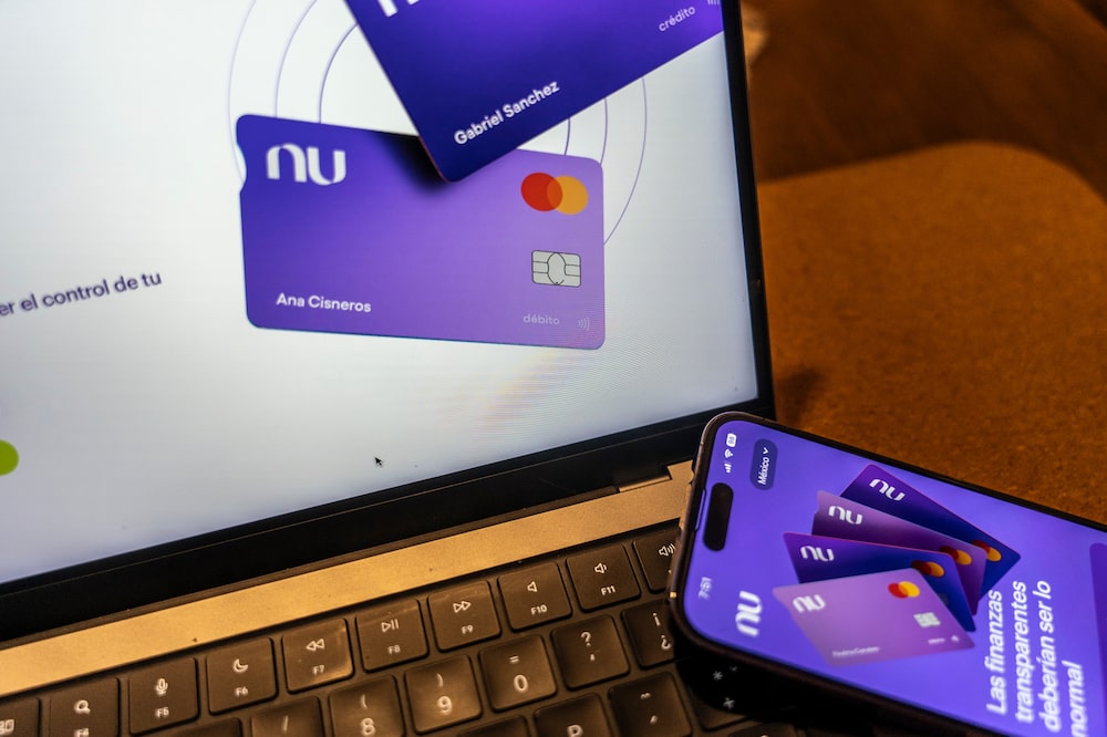 The Nubank website on a laptop arranged in Mexico City, Mexico, on Saturday, Aug. 5, 2023. Nu Holdings Ltd., the Brazilian digital bank that counts Warren Buffett's Berkshire Hathaway Inc. among its biggest stockholders, is betting big that its high-yield savings accounts will stoke growth in Latin America's second-largest economy. Photographer: Alejandro Cegarra/Bloomberg The Nubank website on a laptop arranged in Mexico City, Mexico, on Saturday, Aug. 5, 2023. Nu Holdings Ltd., the Brazilian digital bank that counts Warren Buffett's Berkshire Hathaway Inc. among its biggest stockholders, is betting big that its high-yield savings accounts will stoke growth in Latin America's second-largest economy. Photographer: Alejandro Cegarra/Bloomberg