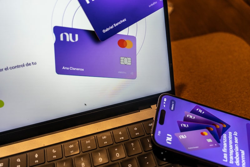 The Nubank website on a laptop arranged in Mexico City, Mexico, on Saturday, Aug. 5, 2023. Nu Holdings Ltd., the Brazilian digital bank that counts Warren Buffett's Berkshire Hathaway Inc. among its biggest stockholders, is betting big that its high-yield savings accounts will stoke growth in Latin America's second-largest economy. Photographer: Alejandro Cegarra/Bloomberg The Nubank website on a laptop arranged in Mexico City, Mexico, on Saturday, Aug. 5, 2023. Nu Holdings Ltd., the Brazilian digital bank that counts Warren Buffett's Berkshire Hathaway Inc. among its biggest stockholders, is betting big that its high-yield savings accounts will stoke growth in Latin America's second-largest economy. Photographer: Alejandro Cegarra/Bloomberg