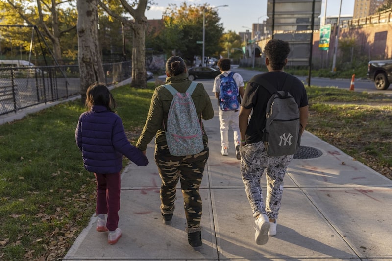 Leydisbell, an immigrant from Venezuela, walks with her kids back to their temporary shelter in the Bronx borough of New York. Leydisbell, an immigrant from Venezuela, walks with her kids back to their temporary shelter in the Bronx borough of New York.