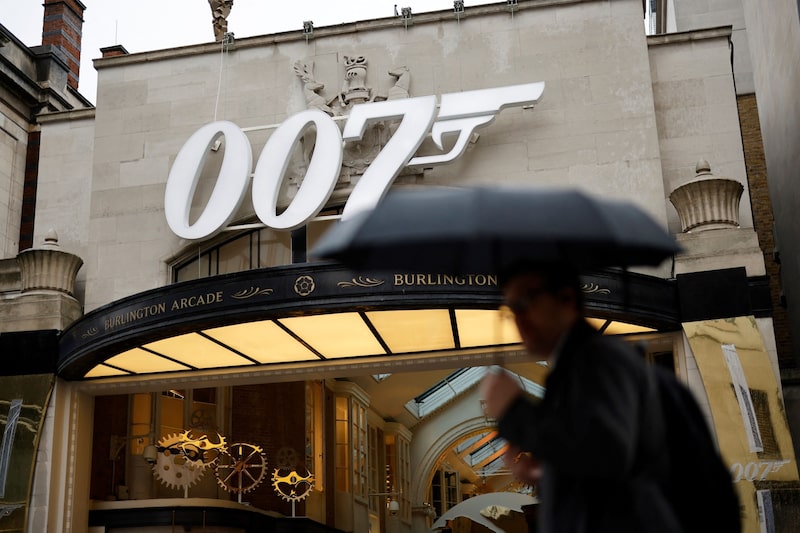 Un peatón pasa junto a un logotipo de James Bond 00, sobre la entrada de Burlington Arcade, en Londres. Fotógrafo: Tolga Akmen/AFP/Getty Images Un peatón pasa junto a un logotipo de James Bond 00, sobre la entrada de Burlington Arcade, en Londres. Fotógrafo: Tolga Akmen/AFP/Getty Images