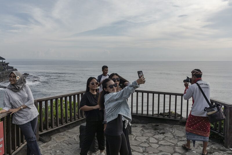 Visitors take selfies in Tanah Lot, Bali, Indonesia Photographer: Nyimas Laula/Bloomberg Visitors take selfies in Tanah Lot, Bali, Indonesia Photographer: Nyimas Laula/Bloomberg
