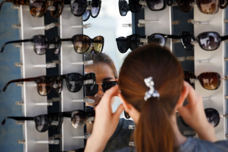 A woman tries on a pair of sunglasses at the Third Street Promenade in Santa Monica, California, U.S., on Monday, May 12, 2014. American consumers took a respite from going to malls and restaurants as retail sales climbed less than forecast in April after the strongest gain in four years, according to figures released by the Commerce Department. The Bloomberg Consumer Comfort Index survey asking Americans to rate the economy and buying climate is scheduled for release on May 15. Photographer: Patrick T. Fallon/Bloomberg A woman tries on a pair of sunglasses at the Third Street Promenade in Santa Monica, California, U.S., on Monday, May 12, 2014. American consumers took a respite from going to malls and restaurants as retail sales climbed less than forecast in April after the strongest gain in four years, according to figures released by the Commerce Department. The Bloomberg Consumer Comfort Index survey asking Americans to rate the economy and buying climate is scheduled for release on May 15. Photographer: Patrick T. Fallon/Bloomberg