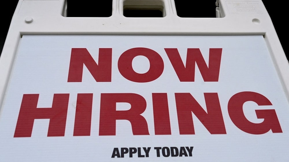 A "Now Hiring" sign is displayed in front of a store on January 13, 2022 in Arlington, Virginia. (Photo by OLIVIER DOULIERY / AFP) (Photo by OLIVIER DOULIERY/AFP via Getty Images) A "Now Hiring" sign is displayed in front of a store on January 13, 2022 in Arlington, Virginia. (Photo by OLIVIER DOULIERY / AFP) (Photo by OLIVIER DOULIERY/AFP via Getty Images)