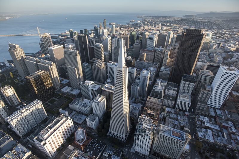 The Transamerica Pyramid building, center, stands in the skyline of downtown as the San Francisco-Oakland Bay Bridge is seen in this aerial photograph taken above San Francisco, California, U.S., on Monday, Oct. 5, 2015. With tech workers flooding San Francisco, one-bedroom apartment rents have climbed to $3,500 a month, more than in any other U.S. city. Photographer: David Paul Morris/Bloomberg The Transamerica Pyramid building, center, stands in the skyline of downtown as the San Francisco-Oakland Bay Bridge is seen in this aerial photograph taken above San Francisco, California, U.S., on Monday, Oct. 5, 2015. With tech workers flooding San Francisco, one-bedroom apartment rents have climbed to $3,500 a month, more than in any other U.S. city. Photographer: David Paul Morris/Bloomberg