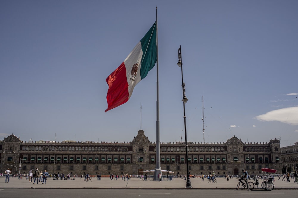 A Mexican flag flies at Constitution Square, known as Zocalo, in Mexico City, Mexico, on Friday Feb. 11, 2022 A Mexican flag flies at Constitution Square, known as Zocalo, in Mexico City, Mexico, on Friday Feb. 11, 2022