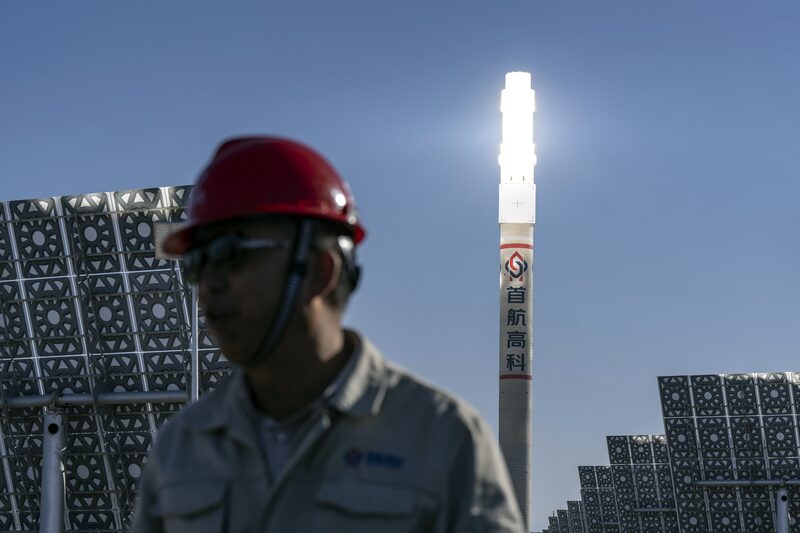 Homem em frente a placas fotovoltaicas Homem em frente a placas fotovoltaicas