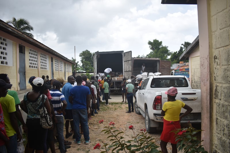 Residentes esperan en fila para recibir bolsas de arroz y aceite de cocina en un lugar de distribución del Programa Mundial de Alimentos (PMA). Residentes esperan en fila para recibir bolsas de arroz y aceite de cocina en un lugar de distribución del Programa Mundial de Alimentos (PMA).