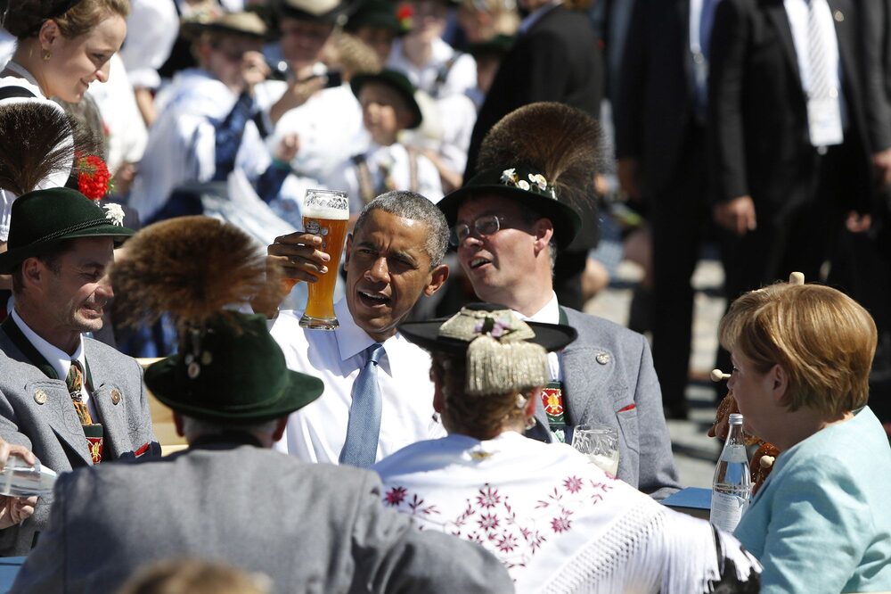 Barack Obama enjoys a beer with Angela Merkel in the morning of the summit of G7 nations on June 7, 2015. Barack Obama enjoys a beer with Angela Merkel in the morning of the summit of G7 nations on June 7, 2015.
