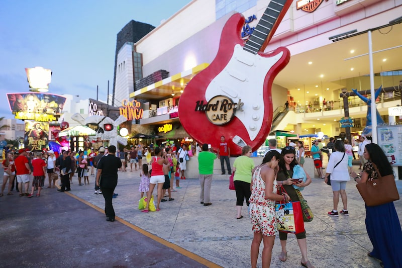 Visitors walk near the Hard Rock Cafe at the Forum By The Sea mall in Cancun, Mexico, on Saturday, April 4, 2015. International tourists exceeded 14.2 million in 2014 while visitors increased 2.8 percent compared to the first half of 2013, reaching 39.4 million according to The Mexico Tourism Board. Photographer: Cassi Alexandra/Bloomberg Visitors walk near the Hard Rock Cafe at the Forum By The Sea mall in Cancun, Mexico, on Saturday, April 4, 2015. International tourists exceeded 14.2 million in 2014 while visitors increased 2.8 percent compared to the first half of 2013, reaching 39.4 million according to The Mexico Tourism Board. Photographer: Cassi Alexandra/Bloomberg
