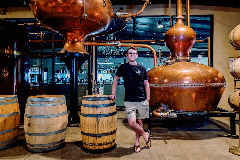 Connor Vaccaro stands near copper stills used in the production of Calavé agave spirit Connor Vaccaro stands near copper stills used in the production of Calavé agave spirit