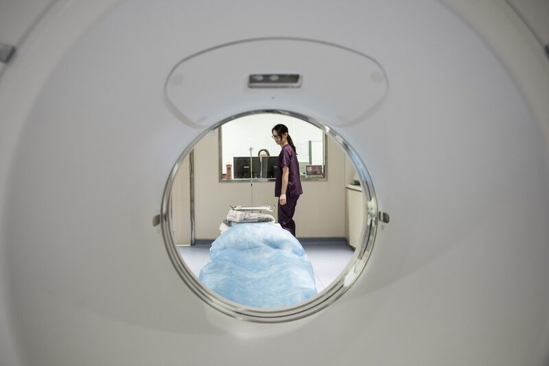 A nurse is seen through a General Electric Co. positron emission tomography (PET) scanner in the diagnostic imaging area at the Hong Kong Integrated Oncology Centre in Hong Kong, China, on Tuesday, Nov. 3, 2015. Equipped with biopsy facilities, body scanners, and quiet 'VIP' chemotherapy rooms, the Hong Kong Integrated Oncology Centre is the first of a string of such facilities that TE Asia Healthcare Partners, a portfolio company funded by TPG Capital, is planning in Asia. Photographer: Xaume Olleros/Bloomberg A nurse is seen through a General Electric Co. positron emission tomography (PET) scanner in the diagnostic imaging area at the Hong Kong Integrated Oncology Centre in Hong Kong, China, on Tuesday, Nov. 3, 2015. Equipped with biopsy facilities, body scanners, and quiet 'VIP' chemotherapy rooms, the Hong Kong Integrated Oncology Centre is the first of a string of such facilities that TE Asia Healthcare Partners, a portfolio company funded by TPG Capital, is planning in Asia. Photographer: Xaume Olleros/Bloomberg