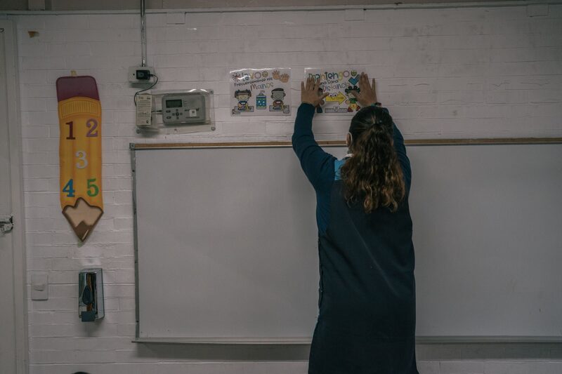 A teacher hangs up drawings illustrating sanitary guidelines at an elementary school on the first day of classes in Mexico City, Mexico, on Monday, Aug. 30, 2021. The new school year begins at a time when Mexico is in the midst of its third wave of COVID-19 infections and has recorded more than 380,000 COVID-19 confirmed deaths, reports ABC News. Photographer: Luis Antonio Rojas/Bloomberg A teacher hangs up drawings illustrating sanitary guidelines at an elementary school on the first day of classes in Mexico City, Mexico, on Monday, Aug. 30, 2021. The new school year begins at a time when Mexico is in the midst of its third wave of COVID-19 infections and has recorded more than 380,000 COVID-19 confirmed deaths, reports ABC News. Photographer: Luis Antonio Rojas/Bloomberg