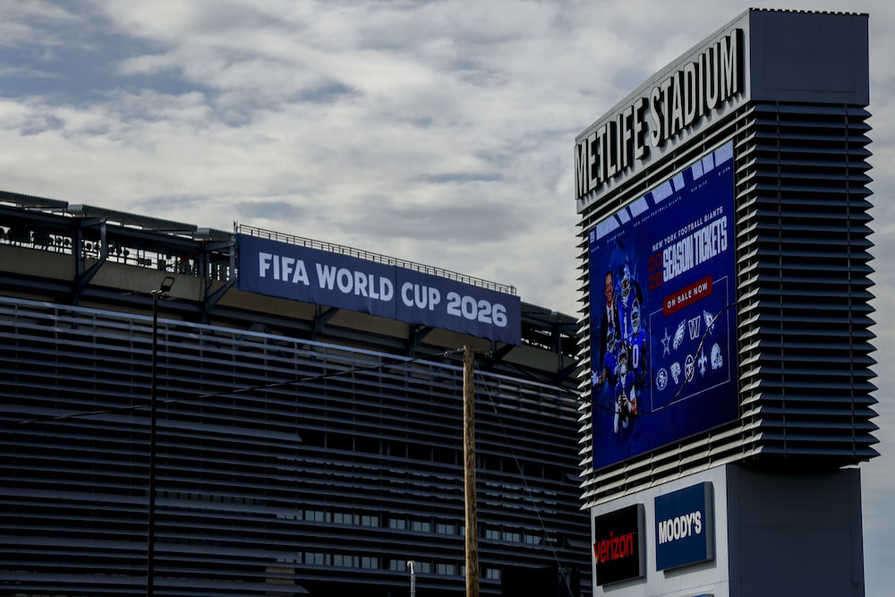 FIFA World Cup 2026 signage at MetLife Stadium, which will host eight FIFA World Cup 2026 games, in East Rutherford, New Jersey, US, on Tuesday, April 21, 2026. Public transport systems are jacking up fares, with New Jersey Transit raising train fares for World Cup matches to $150 round trip, and special shuttle bus tickets running $80, while some stadiums will have limited public service or none at all. Photographer: Michael Nagle/Bloomberg FIFA World Cup 2026 signage at MetLife Stadium, which will host eight FIFA World Cup 2026 games, in East Rutherford, New Jersey, US, on Tuesday, April 21, 2026. Public transport systems are jacking up fares, with New Jersey Transit raising train fares for World Cup matches to $150 round trip, and special shuttle bus tickets running $80, while some stadiums will have limited public service or none at all. Photographer: Michael Nagle/Bloomberg