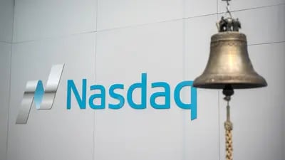 A trading bell hangs in front of Nasdaq signage inside the Nasdaq Swedish Stock Exchange in Stockholm, Sweden, on Thursday, Jan. 31, 2019.