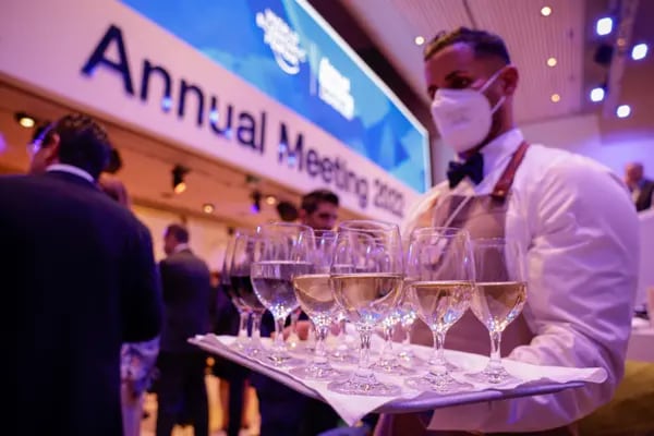 A waiter serves wine during the Welcome Reception ahead of the World Economic Forum (WEF) in Davos, Switzerland.