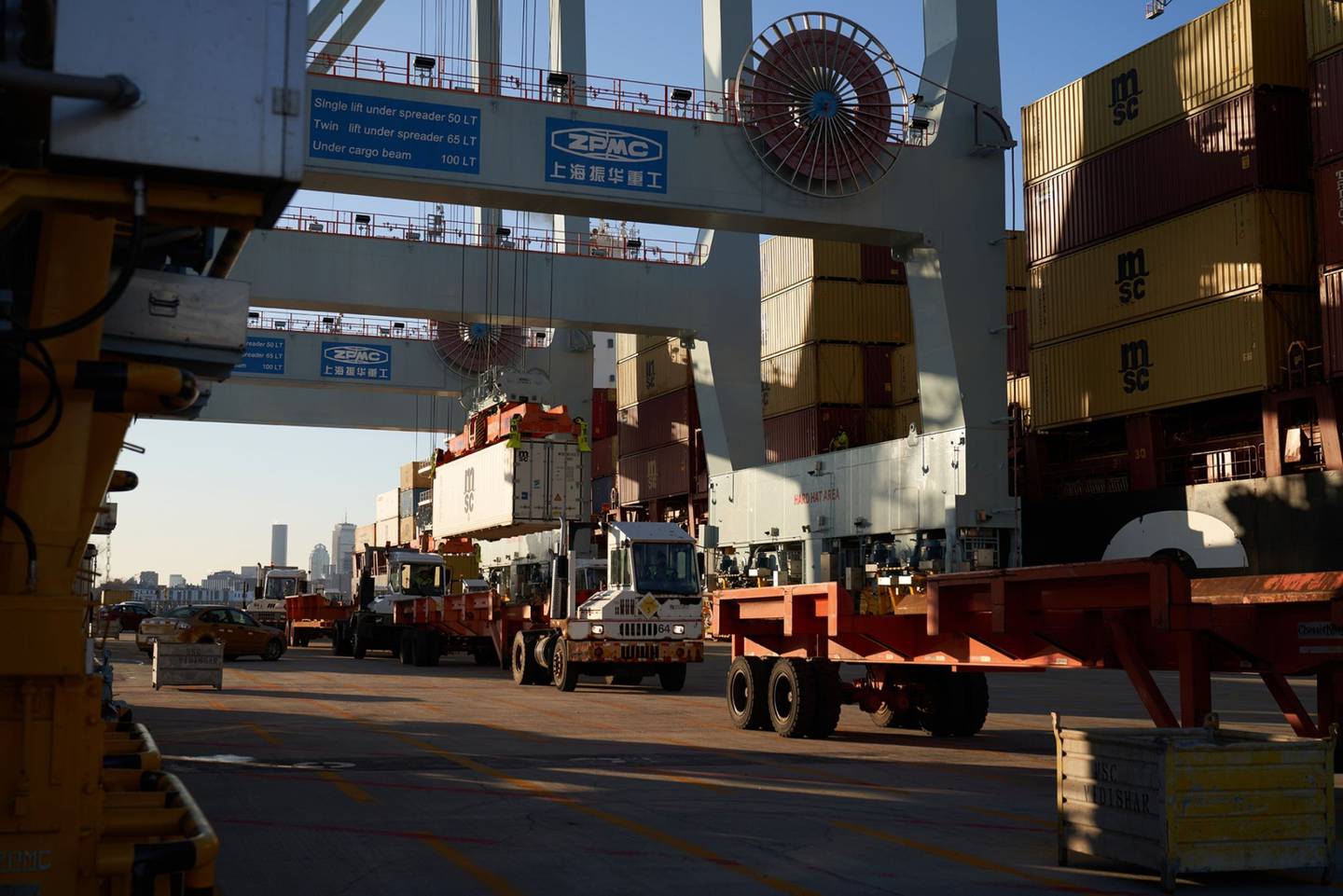 Shipping containers are loaded onto trucks at the Port of Boston's Conley Terminal in Boston, Massachusetts, U.S., on Friday, Jan. 21, 2022. Massport invested $850 million in the Port of Boston Conley Terminal to become big-ship ready and better compete with larger rivals.