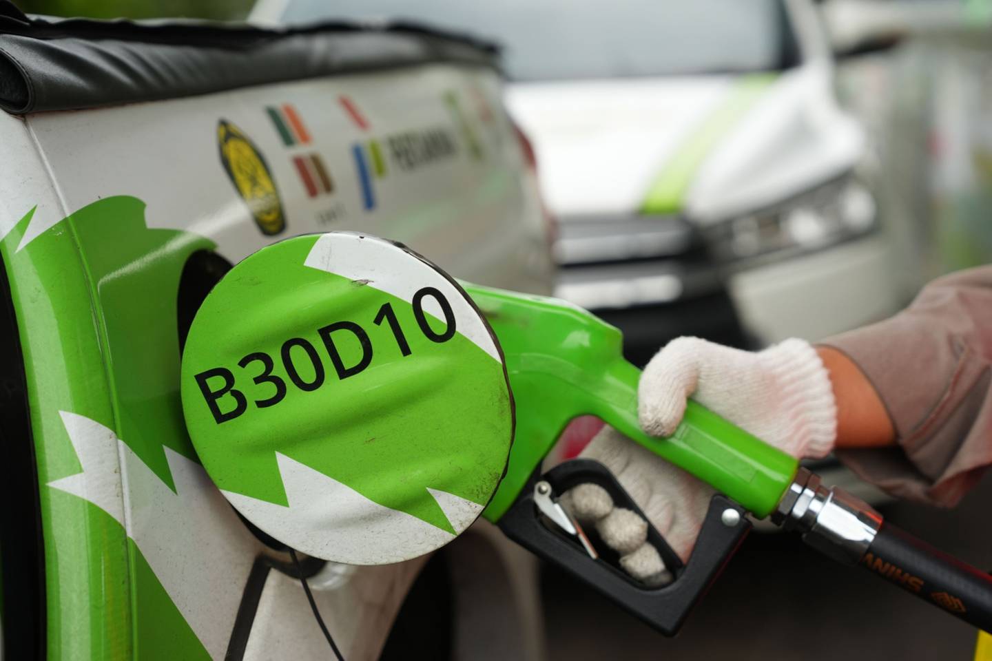 A worker refuels a vehicle during a road test of 40% palm-based biodiesel in Cirebon, West Java, Indonesia.