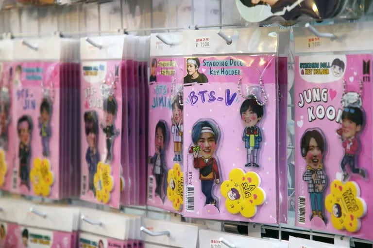 Key holders featuring K-pop boy band BTS are displayed for sale outside a store in Seoul, South Korea, on Friday, Sept. 18. 2020. Big Hit Entertainment Co., the manager of K-pop boy band BTS, is looking to raise as much as 962.6 billion won ($812 million) in a South Korean initial public offering that is set to be the countrys largest in three years. Photographer: SeongJoon Cho/Bloombergdfd
