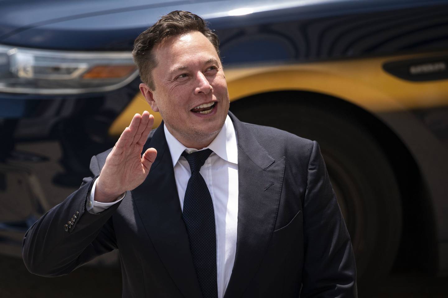 Elon Musk, chief executive officer of Tesla Inc., waves while departing court during the SolarCity trial in Wilmington, Delaware, U.S., on Tuesday, July 13, 2021. Photographer: Al Drago/Bloomberg