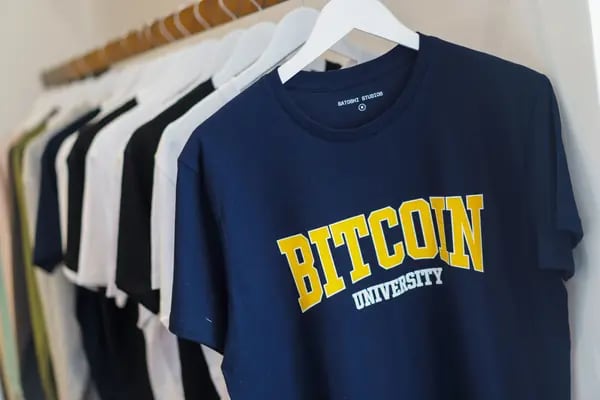 A Bitcoin University t-shirt for sale inside a cryptocurrency exchange in Madrid, Spain.