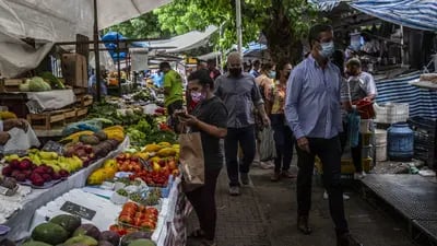 Shoppers browse stalls of fresh fruits and vegetables at a street market in the Ipanema neighborhood Rio de Janeiro