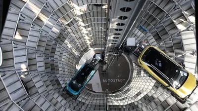 A VW ID.3, left, and ID.4 inside a delivery tower in Wolfsburg, Germany. Photographer: Liesa Johannssen-Koppitz/Bloomberg